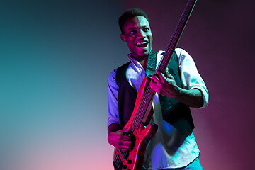 Image showing African American jazz musician playing bass guitar.