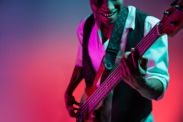 Image showing African American jazz musician playing bass guitar.