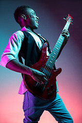 Image showing African American jazz musician playing bass guitar.