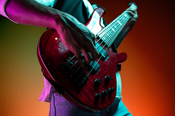 Image showing African American jazz musician playing bass guitar.