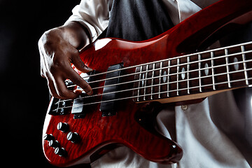 Image showing African American jazz musician playing bass guitar.