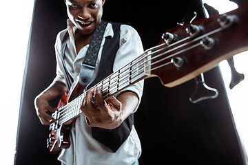 Image showing African American jazz musician playing bass guitar.