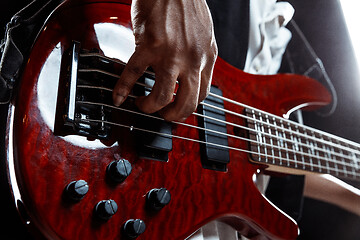 Image showing African American jazz musician playing bass guitar.