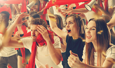 Image showing Group of happy fans are cheering for their team victory.