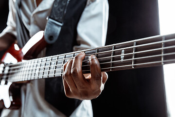 Image showing African American jazz musician playing bass guitar.