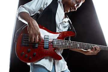 Image showing African American jazz musician playing bass guitar.