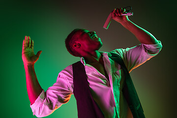 Image showing African American handsome jazz musician singing.