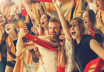 Image showing Group of happy fans are cheering for their team victory.