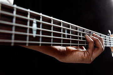 Image showing African American jazz musician playing bass guitar.