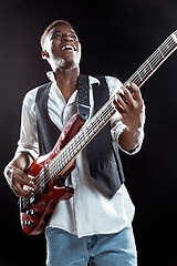 Image showing African American jazz musician playing bass guitar.