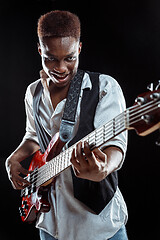 Image showing African American jazz musician playing bass guitar.
