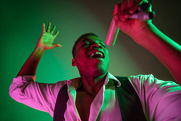 Image showing African American handsome jazz musician singing.