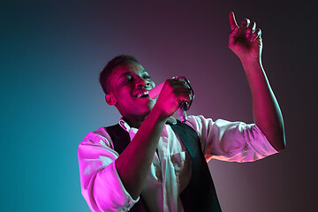 Image showing African American handsome jazz musician singing.