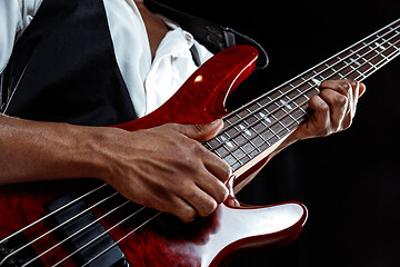 Image showing African American jazz musician playing bass guitar.