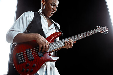 Image showing African American jazz musician playing bass guitar.