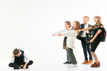 Image showing Little boy sitting alone on floor and suffering an act of bullying.