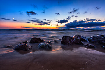 Image showing Sea sunset seascape with wet rocks