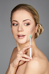 Image showing beautiful girl holding syringe