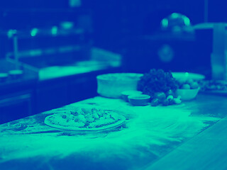 Image showing chef putting fresh vegetables on pizza dough