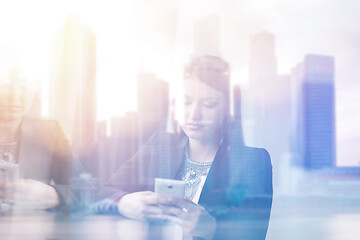 Image showing Business Girl Standing In A Modern Building Near The Window With