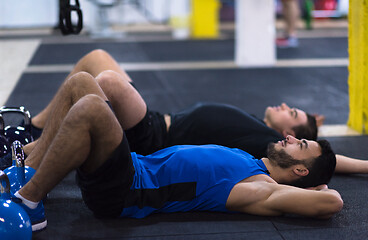 Image showing young athletes lying on the floor and relaxing