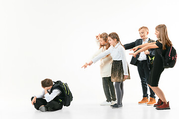 Image showing Little boy sitting alone on floor and suffering an act of bullying.