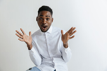 Image showing Portrait of excited young African American male screaming in shock and amazement.