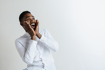 Image showing Portrait of excited young African American male screaming in shock and amazement.