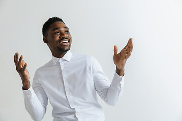 Image showing Portrait of excited young African American male screaming in shock and amazement.