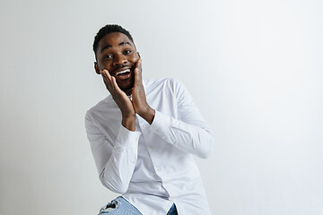 Image showing Portrait of excited young African American male screaming in shock and amazement.