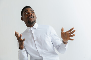 Image showing Portrait of excited young African American male screaming in shock and amazement.