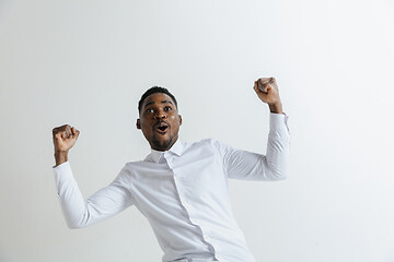 Image showing Portrait of excited young African American male screaming in shock and amazement.