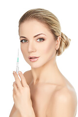 Image showing beautiful girl holding syringe isolated on white