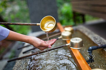 Image showing Woman washing hand in water fountain