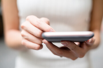 Image showing Close up of woman sending sms on cellphone