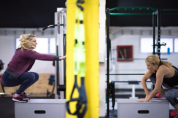 Image showing athletes working out  jumping on fit box