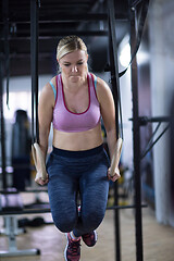 Image showing woman working out pull ups with gymnastic rings