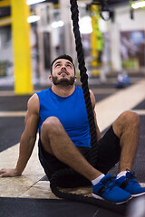 Image showing man relaxing before rope climbing