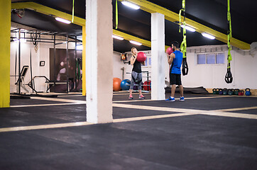 Image showing young athletes couple working out with medical ball