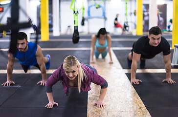 Image showing young healthy people doing pushups