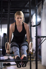 Image showing woman working out pull ups with gymnastic rings