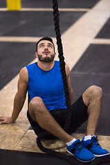 Image showing man relaxing before rope climbing