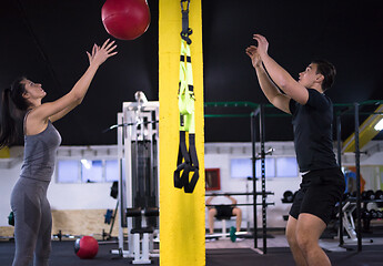 Image showing young athletes couple working out with medical ball