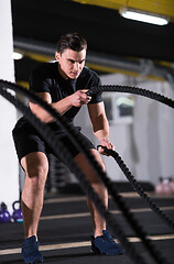 Image showing athlete man doing battle ropes cross fitness exercise