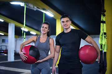 Image showing young athletes couple working out with medical ball