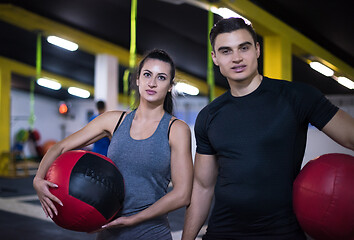 Image showing young athletes couple working out with medical ball