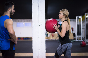 Image showing young athletes couple working out with medical ball