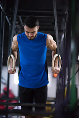 Image showing man working out pull ups with gymnastic rings