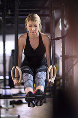 Image showing woman working out pull ups with gymnastic rings