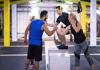 Image showing athletes working out  jumping on fit box